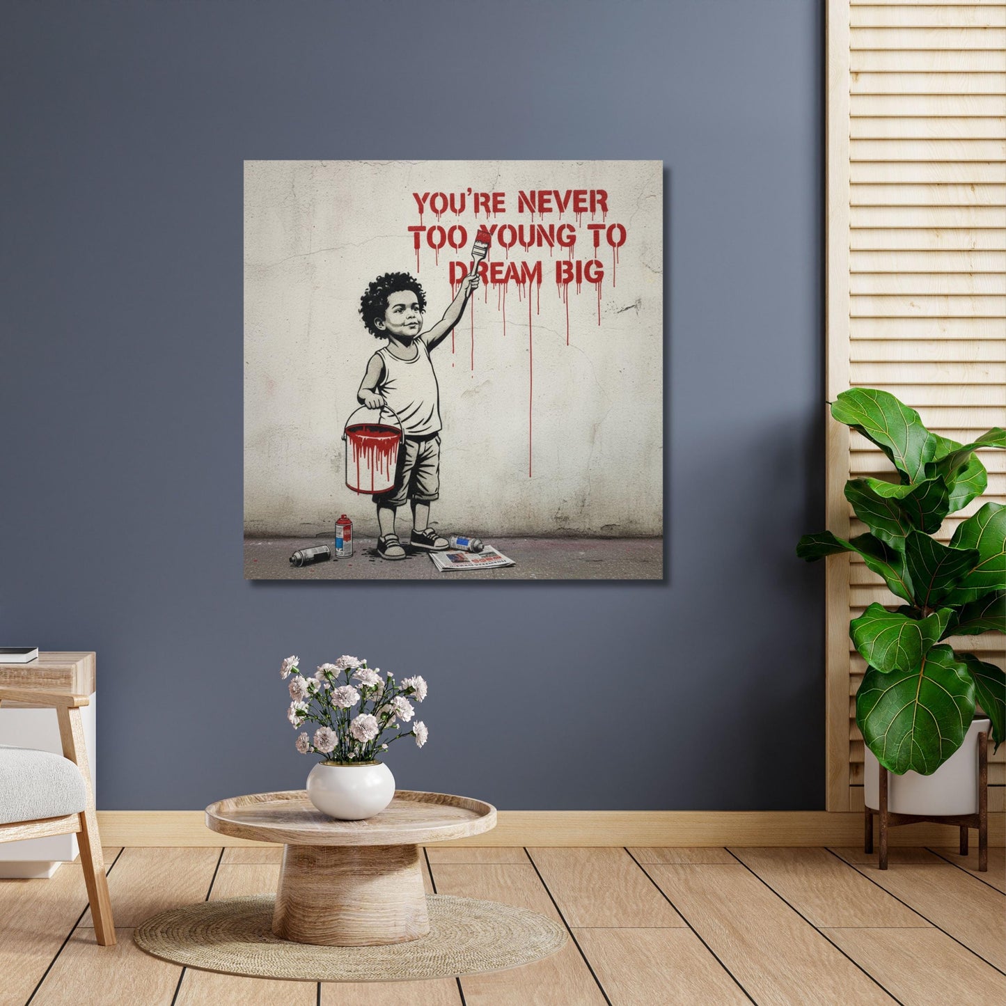 a painting of a young boy holding a bucket of paint, with the text "YOU'RE NEVER TOO YOUNG TO DREAM BIG" written above him.