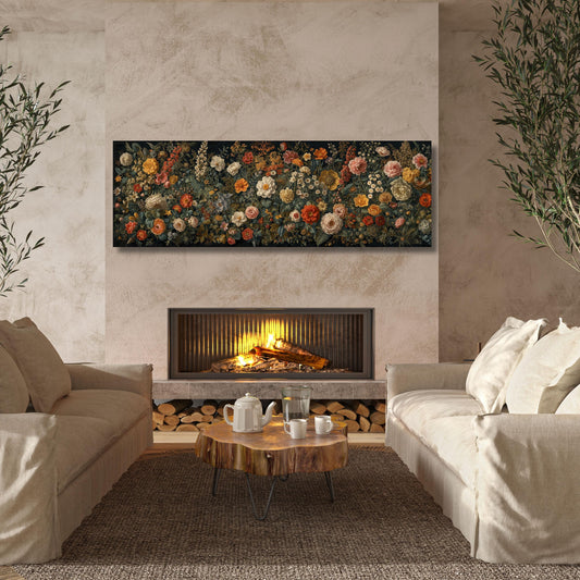 May include: A long, rectangular floral canvas print featuring a variety of flowers in shades of red, orange, yellow, and white. The artwork hangs above a fireplace with a lit fire. The room includes two beige sofas, a wooden coffee table, and a rug.