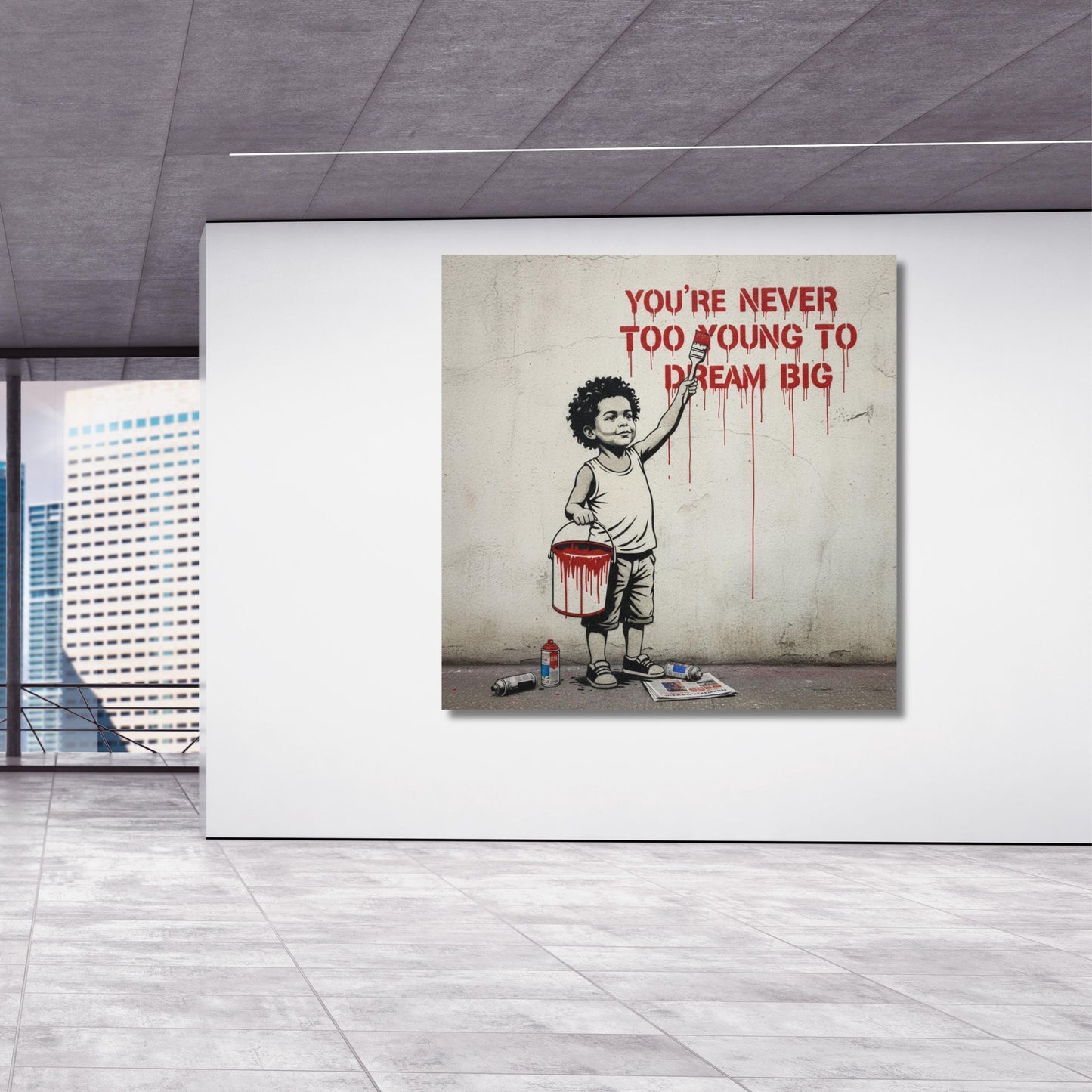 The image is a graffiti-style artwork depicting a young boy holding a paint bucket, with the text "YOU'RE NEVER TOO YOUNG TO DREAM BIG" written above him.
